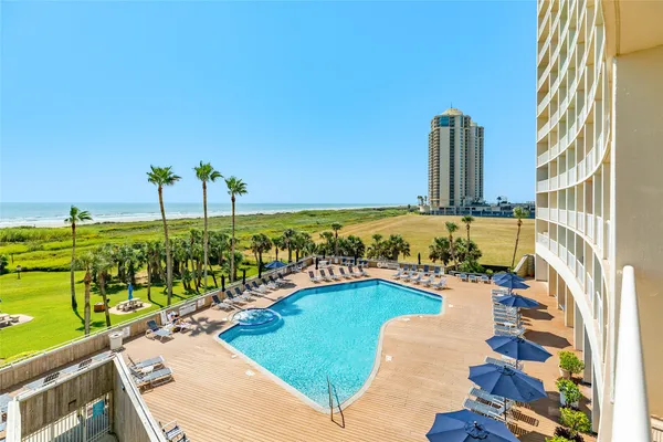 a view of a swimming pool with an outdoor seating