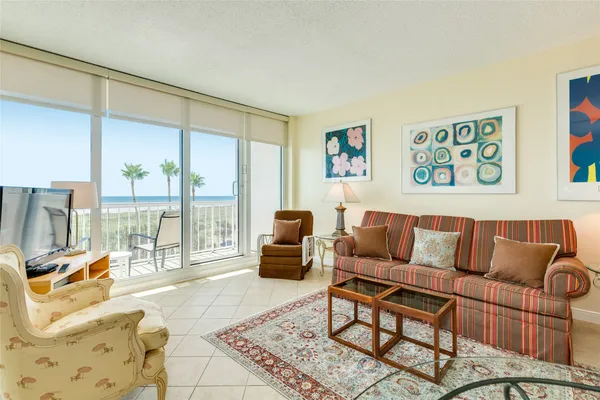 a living room with furniture and a floor to ceiling window