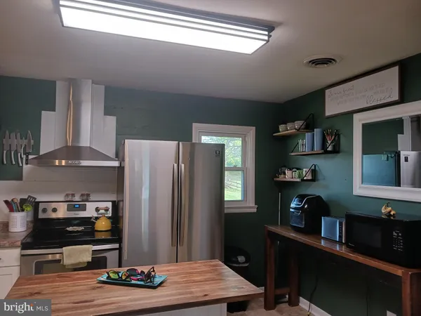 a kitchen with stainless steel appliances granite countertop a refrigerator