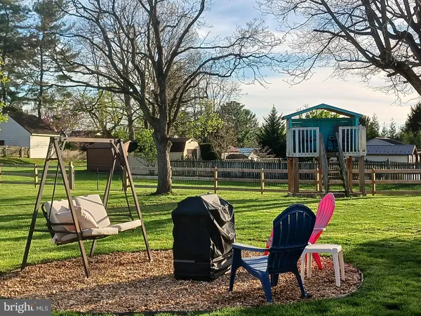 a view of a table and chairs in patio and a yard