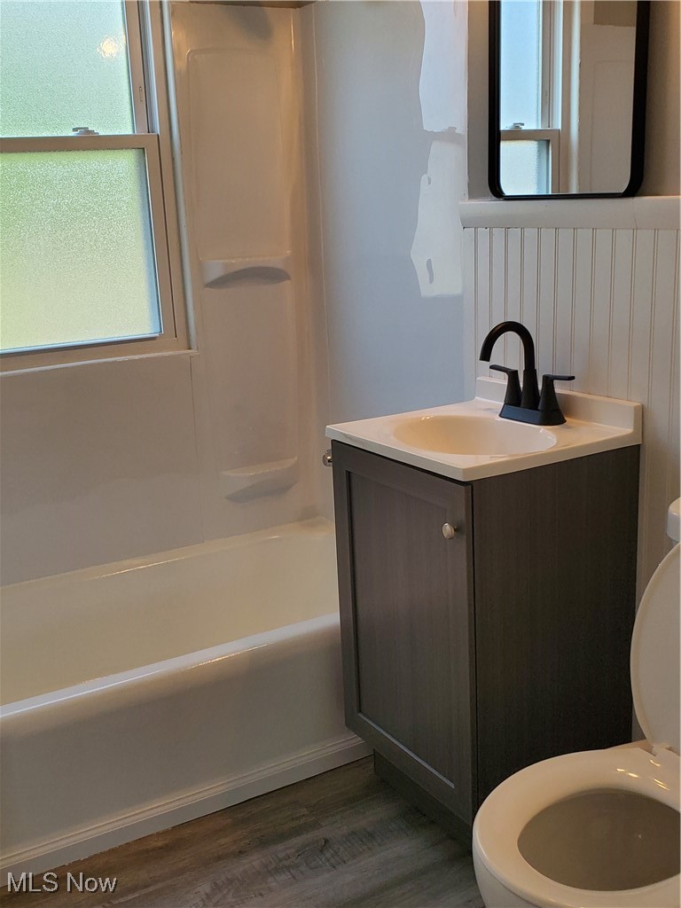7007 Biddulph Road Brooklyn, OH 44144 - Photo 12 of 16 Full bath featuring toilet, vanity, wood finished floors, and shower / tub combination