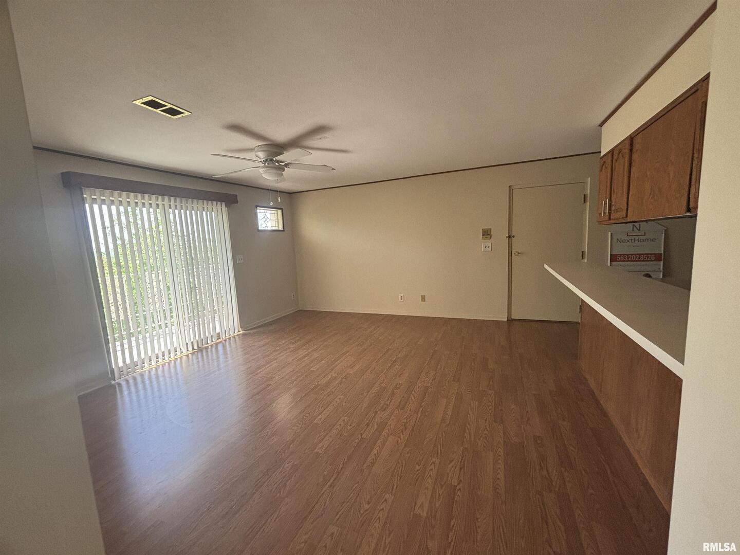 920 17th Street, Unit 28 Moline, IL 61265 - Photo 13 of 17 an empty room with wooden floor fan and windows