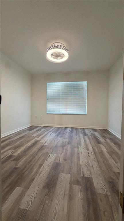 1941 Brancaster Circle Ocoee, FL 34761 - Photo 21 of 33 a view of an empty room with a window and wooden floor