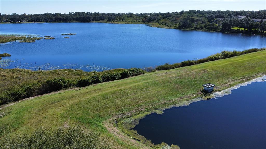 1941 Brancaster Circle Ocoee, FL 34761 - Photo 27 of 33 a view of a lake with houses in the back