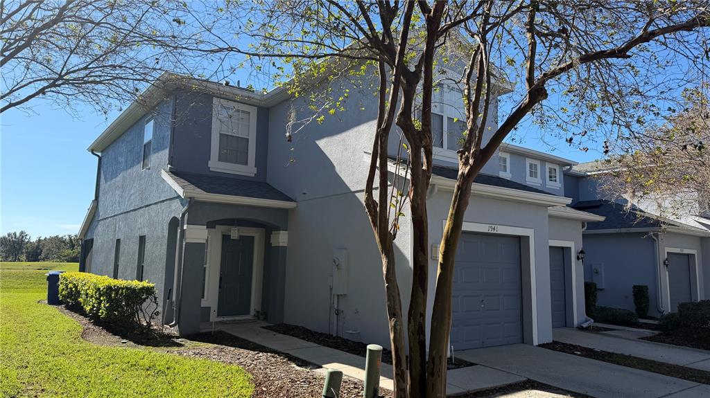1941 Brancaster Circle Ocoee, FL 34761 - Photo 3 of 33 a yellow house with trees in front of it