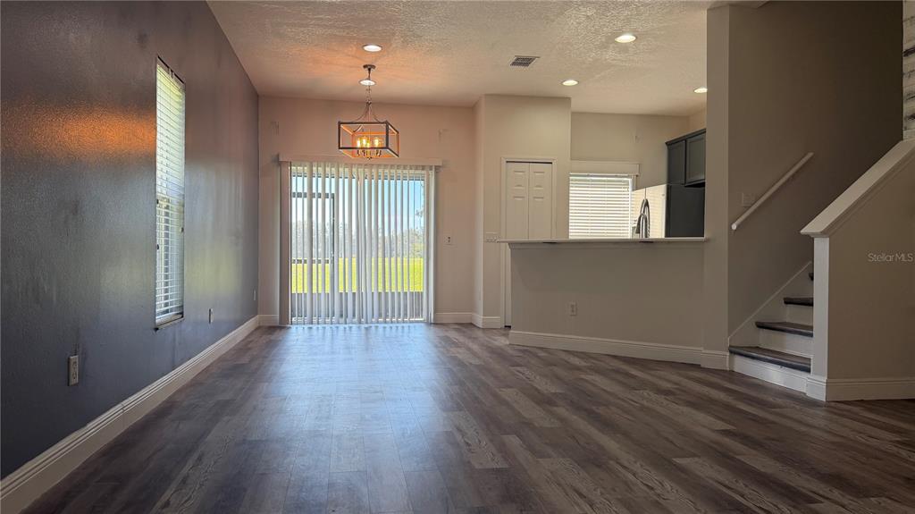 1941 Brancaster Circle Ocoee, FL 34761 - Photo 5 of 33 an empty room with wooden floor and windows