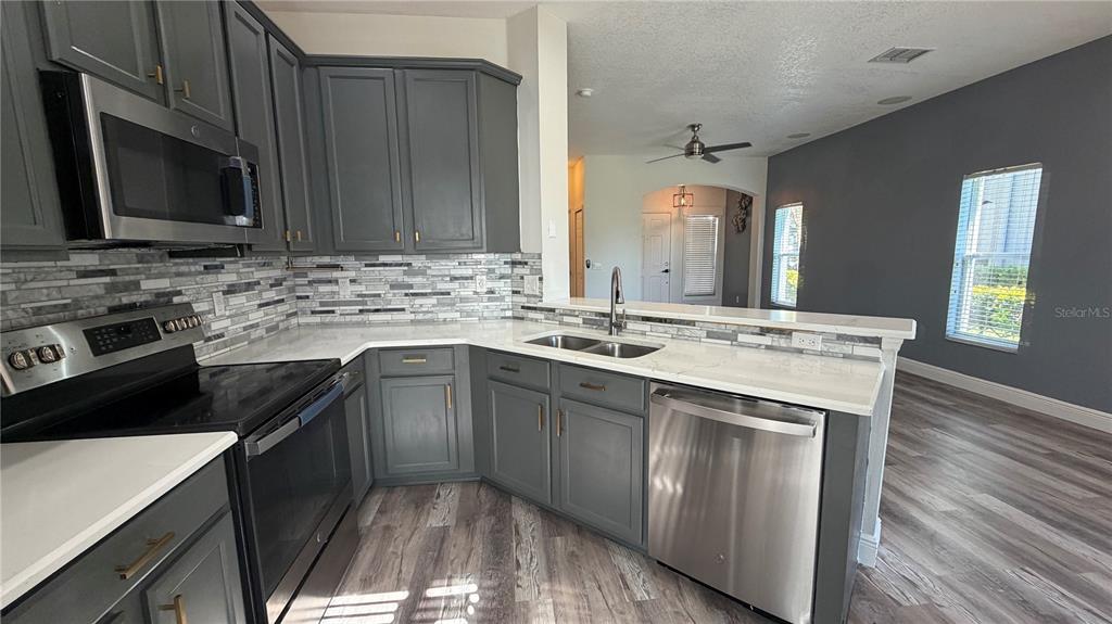 1941 Brancaster Circle Ocoee, FL 34761 - Photo 9 of 33 a kitchen with a sink stove and microwave