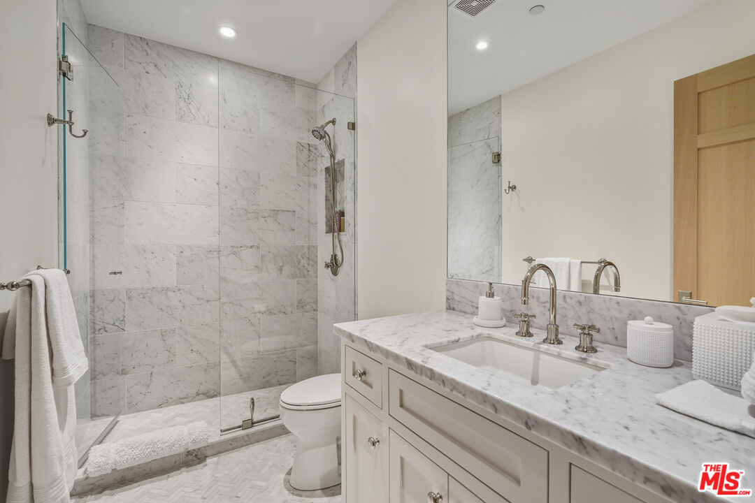3140 Sweetwater Mesa Road Malibu, CA 90265 - Photo 57 of 71 a bathroom with a granite countertop sink a toilet and shower