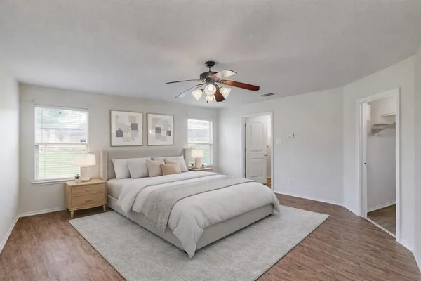 a bedroom with a large bed and a chandelier