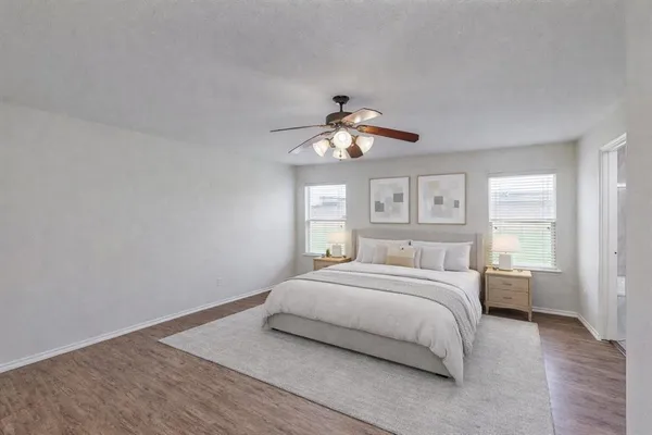 a bedroom with a large bed and a chandelier