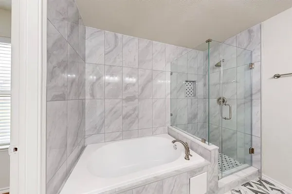 a bathroom with a bathtub and shower