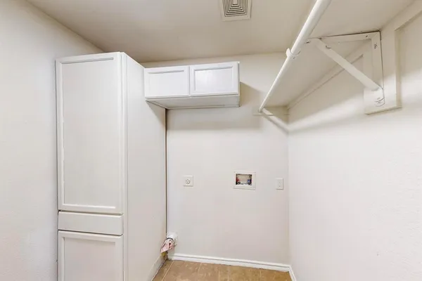 a view of walk in closet with white walls