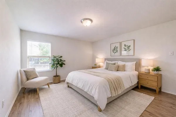 a bedroom with a large bed and a couch