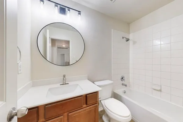a bathroom with a sink a toilet and a mirror