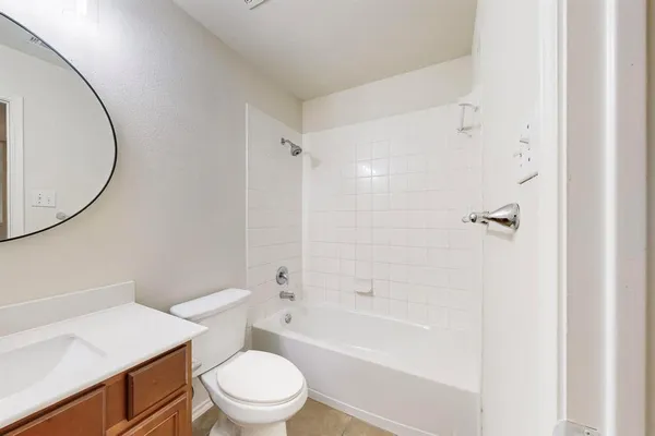 a white toilet sitting next to a bath tub