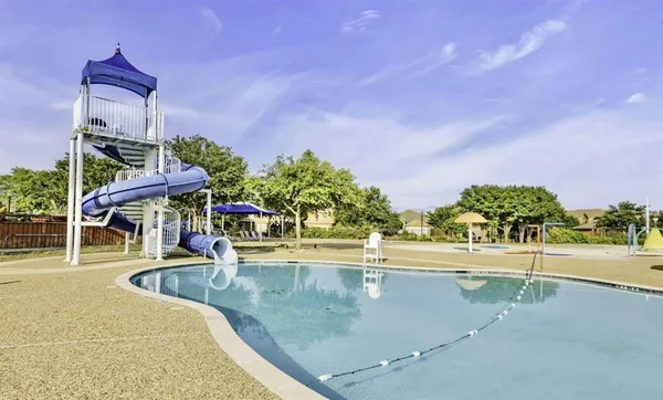 a view of a swimming pool with an outdoor seating