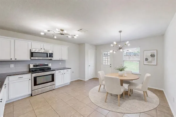 a view of kitchen with sink and microwave