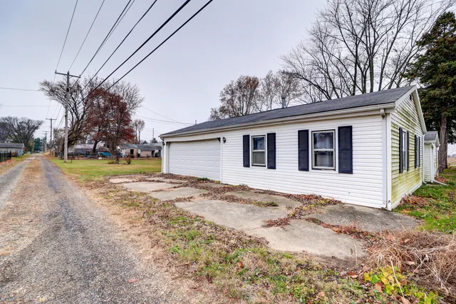 a view of a house with a yard and pathway