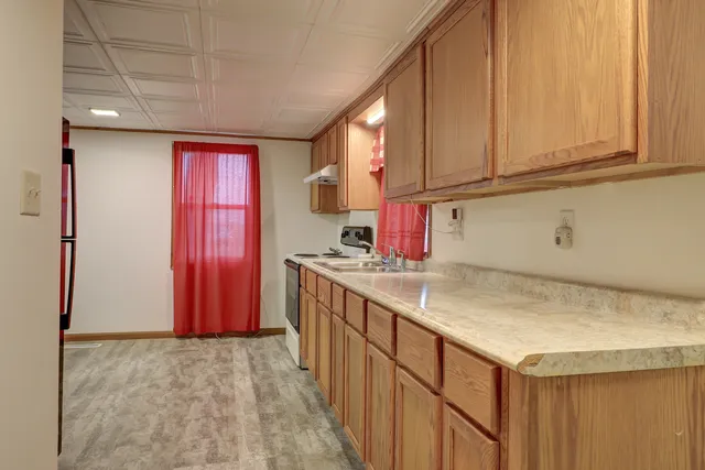 a kitchen with sink cabinets and window