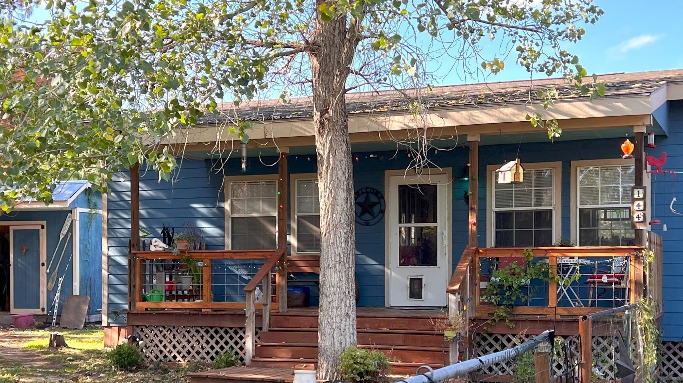 144 Cardinal Loop Paige, TX 78659 - Photo 1 of 1 a view of a house with a tree