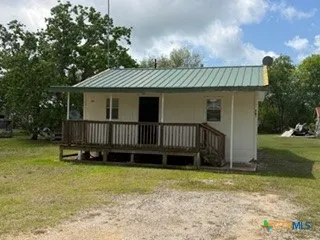 a view of a house with a backyard and swing