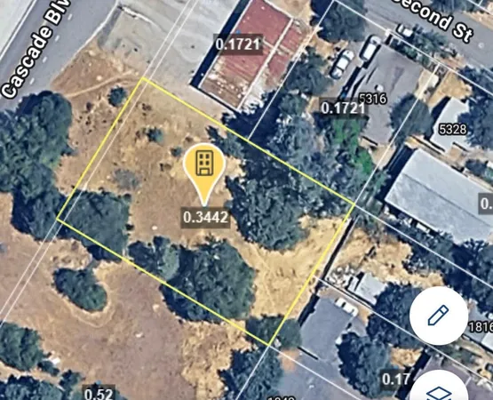 an aerial view of a house with a backyard