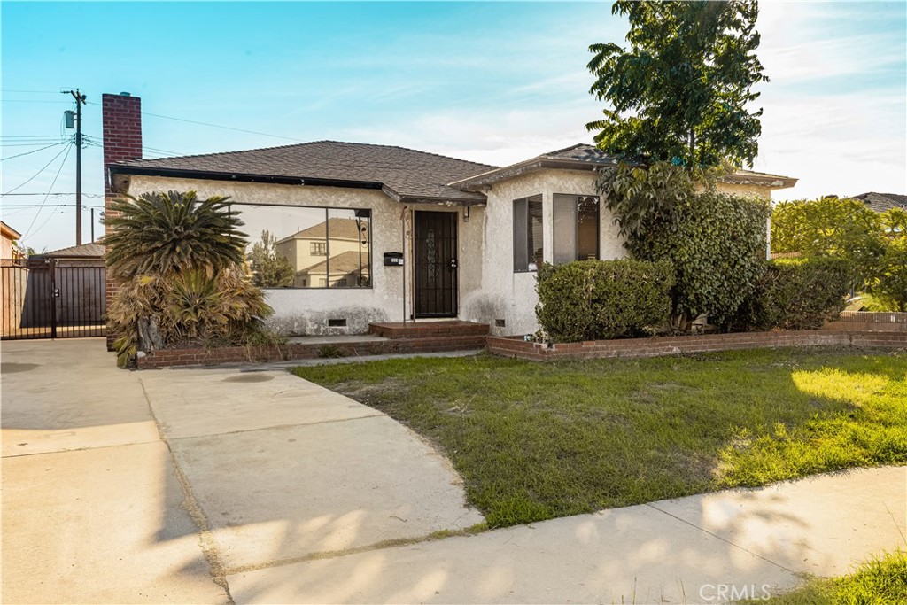 9044 Oak Street Bellflower, CA 90706 - Photo 2 of 30 a front view of a house with garden