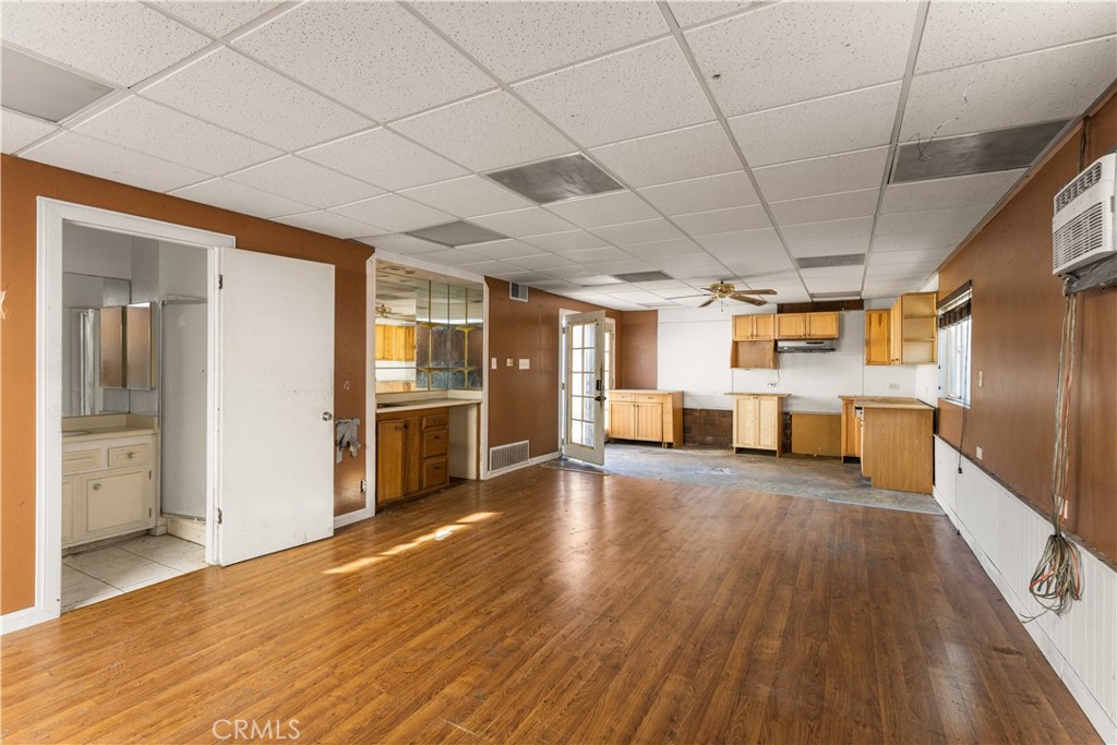 9044 Oak Street Bellflower, CA 90706 - Photo 26 of 30 a large space with stainless steel appliances wooden floor and chandelier