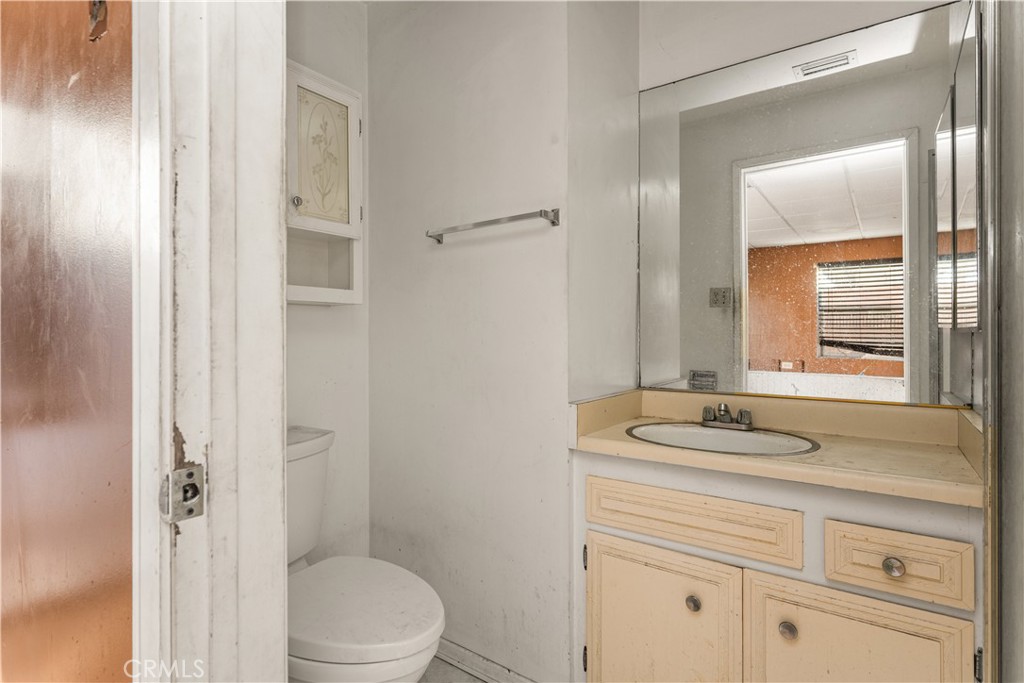 9044 Oak Street Bellflower, CA 90706 - Photo 27 of 30 a bathroom with a sink and a mirror