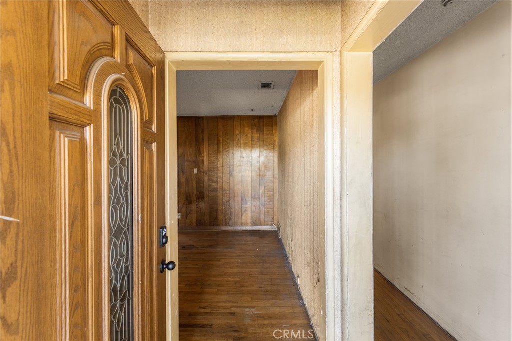9044 Oak Street Bellflower, CA 90706 - Photo 3 of 30 a view of a entryway door with wooden floor
