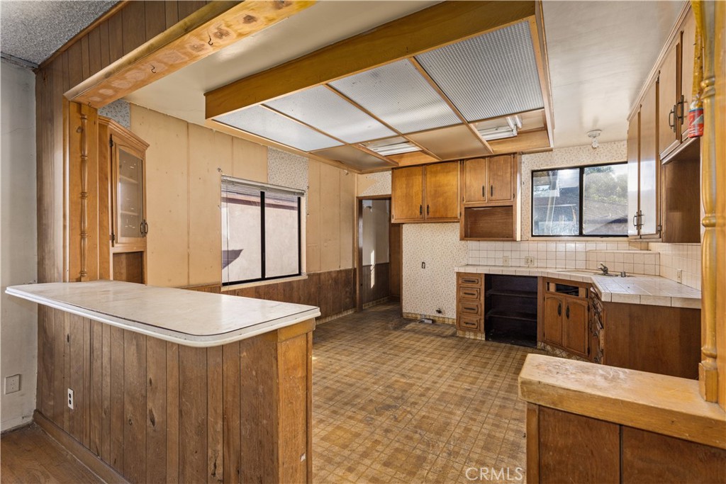 9044 Oak Street Bellflower, CA 90706 - Photo 7 of 30 a kitchen with a stove a sink and a refrigerator