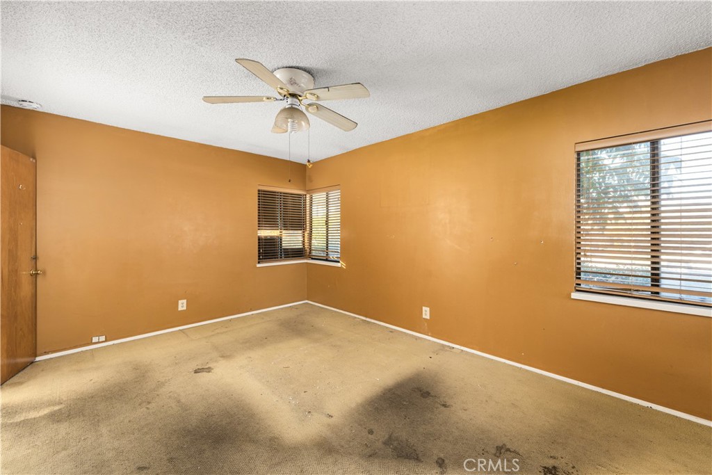 9044 Oak Street Bellflower, CA 90706 - Photo 10 of 30 a view of a big room with wooden floor and chandelier fan