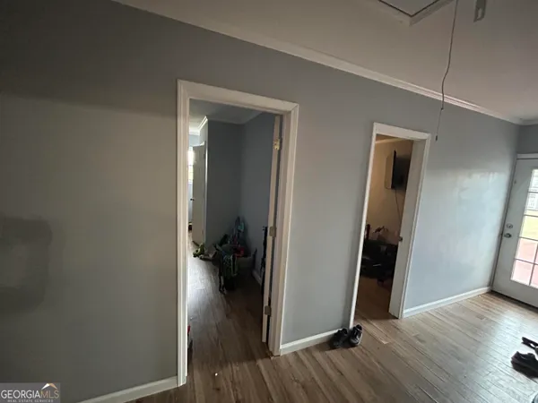 a view of a dining room with furniture a chandelier and wooden floor
