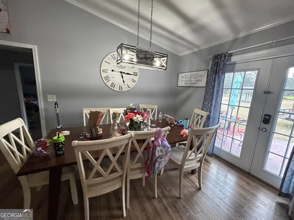 a large kitchen with lots of counter space and a wooden floor