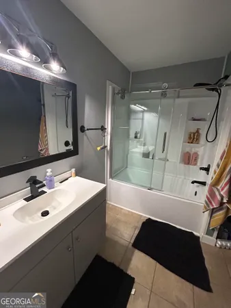 a bathroom with a double vanity sink and mirror
