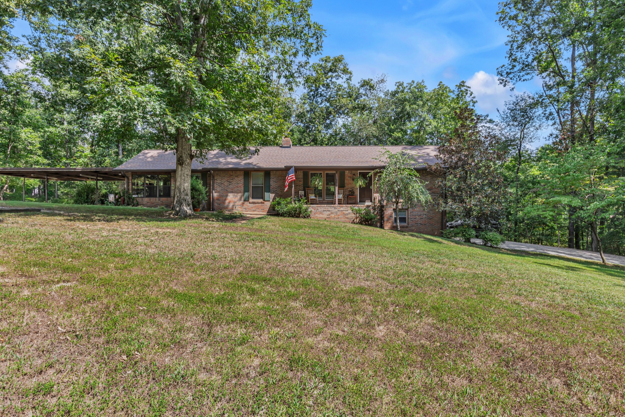 a view of house with yard and outdoor seating