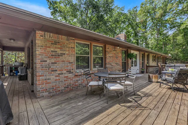 a view of chairs and table in the roof deck