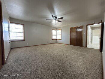 8302 Interstate 27 Lubbock, TX 79423 - Photo 12 of 21 a view of empty room with windows and ceiling fan