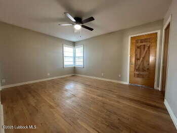 8302 Interstate 27 Lubbock, TX 79423 - Photo 16 of 21 an empty room with wooden floor and windows