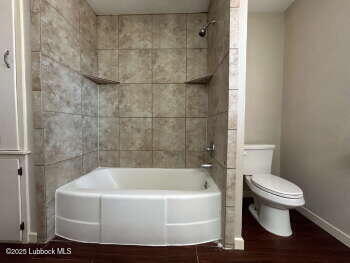 8302 Interstate 27 Lubbock, TX 79423 - Photo 18 of 21 a white bath tub sitting next to a white toilet