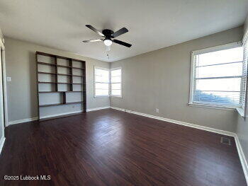 8302 Interstate 27 Lubbock, TX 79423 - Photo 19 of 21 a view of wooden floor and windows in a room