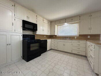 8302 Interstate 27 Lubbock, TX 79423 - Photo 6 of 21 a kitchen with stainless steel appliances granite countertop a stove a sink and a microwave