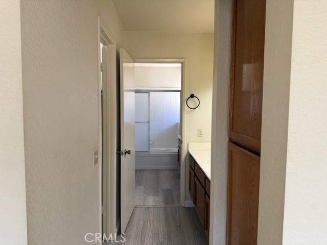 10581 Sunburst Drive Rancho Cucamonga, CA 91730 - Photo 13 of 19 a bathroom with a glass shower door and a mirror