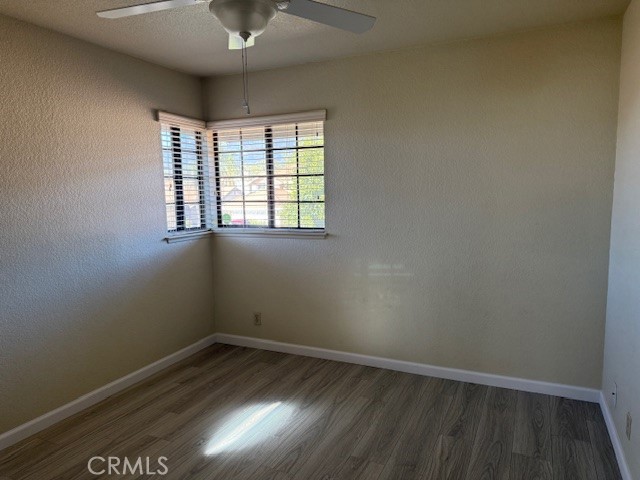 10581 Sunburst Drive Rancho Cucamonga, CA 91730 - Photo 16 of 19 an empty room with wooden floor and windows