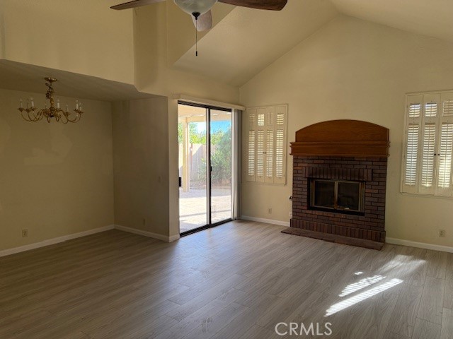10581 Sunburst Drive Rancho Cucamonga, CA 91730 - Photo 6 of 19 an empty room with wooden floor fireplace and windows