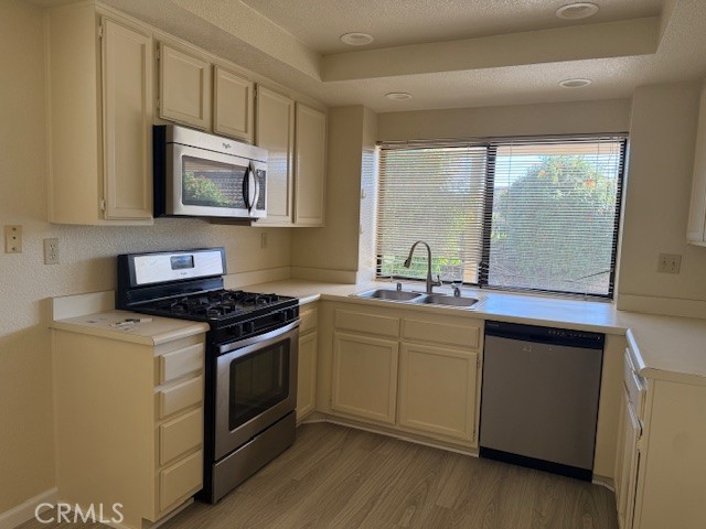 10581 Sunburst Drive Rancho Cucamonga, CA 91730 - Photo 8 of 19 a kitchen with stainless steel appliances granite countertop a stove and a microwave
