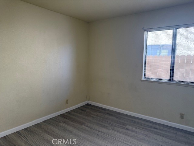 10581 Sunburst Drive Rancho Cucamonga, CA 91730 - Photo 9 of 19 an empty room with wooden floor and windows