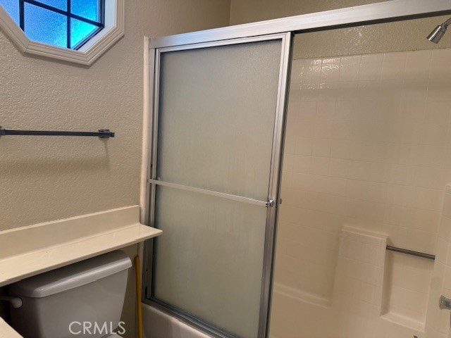 10581 Sunburst Drive Rancho Cucamonga, CA 91730 - Photo 10 of 19 a bathroom with a glass shower door