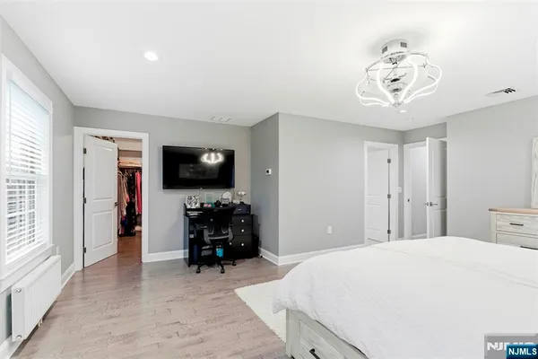 a bedroom with a bed and a television in it