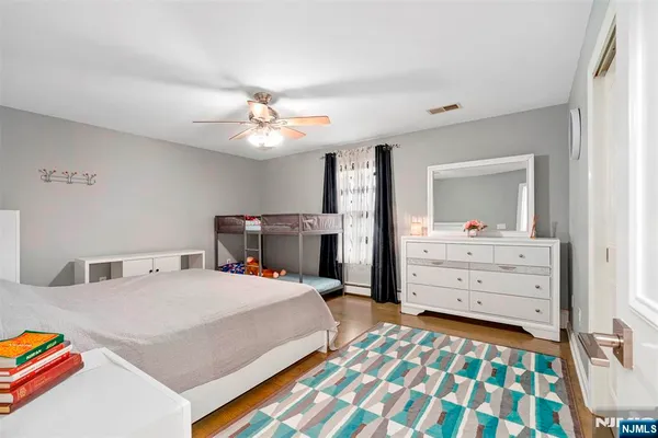 a bedroom with a bed and a dresser